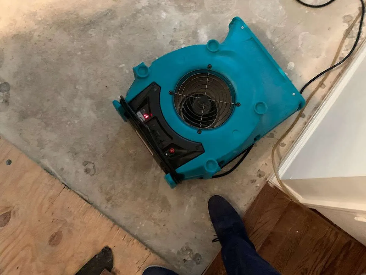 Air mover drying subfloor during Commercial Water Damage Restoration in Worcester